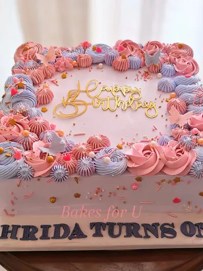 A closer look at the gorgeous floral piping on the square first birthday cake.