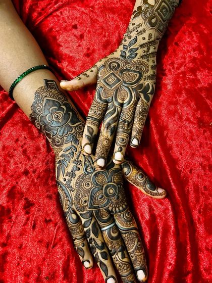 A gorgeous example of layered floral and geometric patterns. The hands are posed to show how the designs on each hand complement one another.