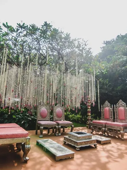 For Jenita and Vinit, we designed a 'Tree of Love' mandap. Instead of building a structure, we used a gorgeous existing champa tree and suspended thousands of fragrant rajnigandha strings from its branches, creating a truly organic and unforgettable sacred space.