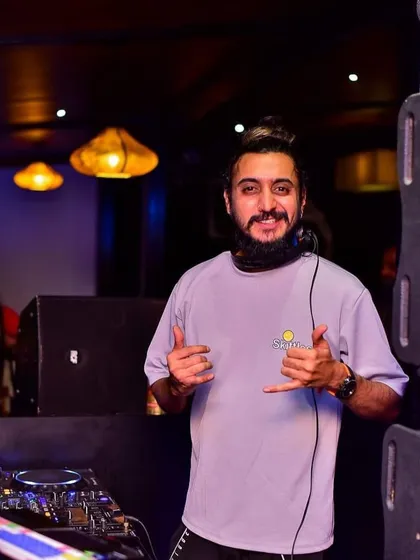 The 'shaka' sign for good vibes. It's all about spreading positivity and enjoying the music together.