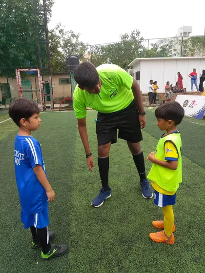 Two of our youngest players, representing their teams as captains. We believe in giving them leadership roles early to build confidence.