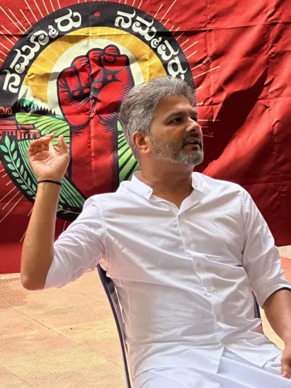 Speaking with passion and purpose in front of our movement's banner. My commitment is to articulate the aspirations of our people and work tirelessly to achieve them.