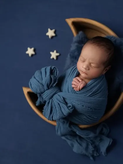 A slightly different angle of the blue moon setup, showcasing the texture of the wrap and the baby's serene expression.