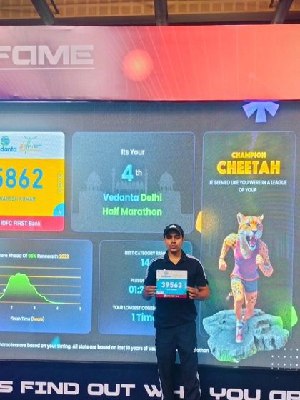 Holding my bib number in front of my race stats.