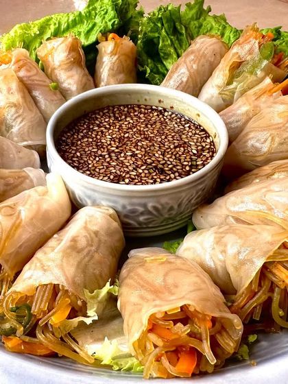 Another beautiful platter of our Vietnamese rolls, arranged in a circle around the savory dipping sauce, ready to be served at your party.
