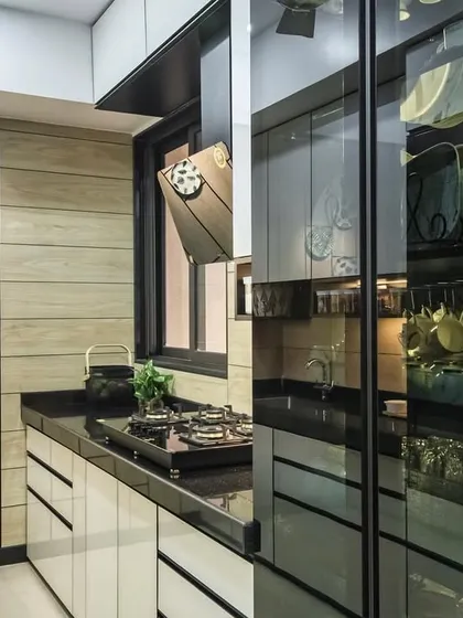 This shot showcases the integrated glass pantry unit in the Lodha Park kitchen, which serves as both storage and a design feature.