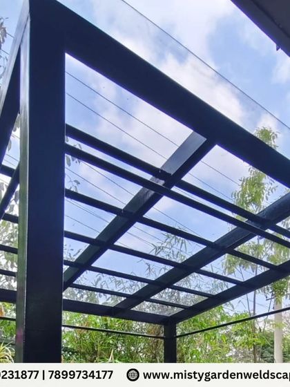 Another perspective of the sleek, black-framed compact sheet pergola. The clean lines and transparent roof make the structure feel light and unobtrusive, blending seamlessly with the garden.