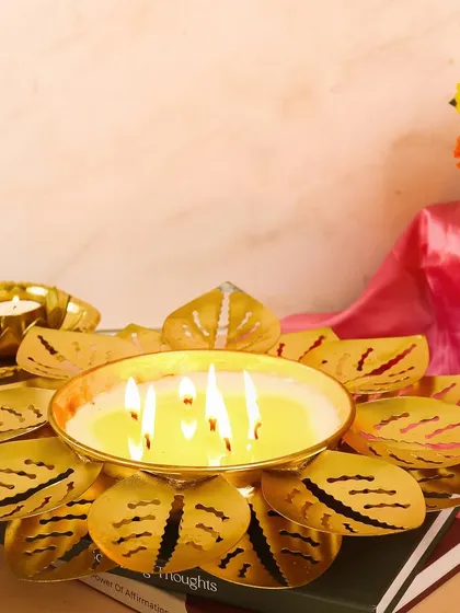 This is our showstopper Lotus Urli Candle Bowl, a multi-wick, scented centerpiece that brings a grand, festive glow to any space. It's perfect for making a statement during Diwali or any special occasion.