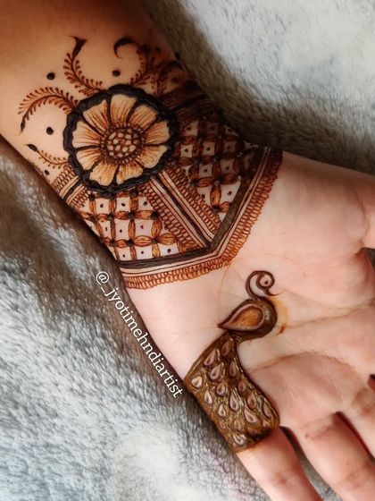 Another view of the minimal peacock and floral cuff design. The simplicity of the pattern makes it very striking.