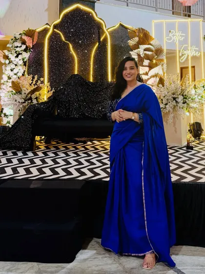 Posing in a royal blue saree gown before hosting a reception. The elegant black and white chevron stage design called for a bold and sophisticated look.