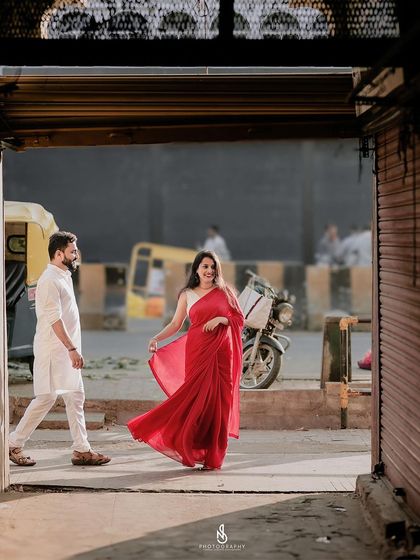 A candid shot of the couple walking through the city, framed by a doorway. This composition adds a layer of storytelling to the image.