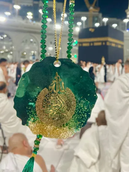 A luxurious car hanging in an emerald green and gold design, featuring Ayat ul Kursi. It's paired with a matching crystal tasbeeh, making it a beautiful spiritual accessory for your vehicle.