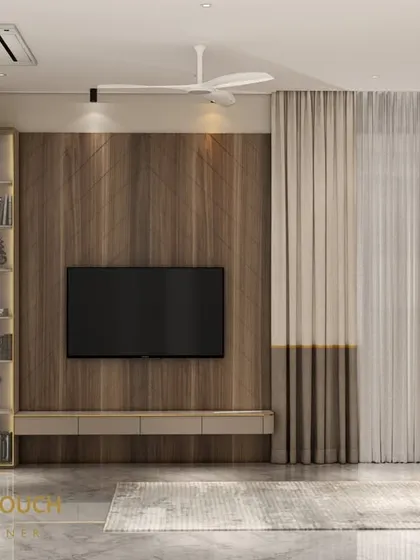 This image shows the living area connected to the bedroom, featuring a wooden feature wall for the TV and a built-in bookshelf. This demonstrates our approach to creating cohesive, multi-functional master suites.