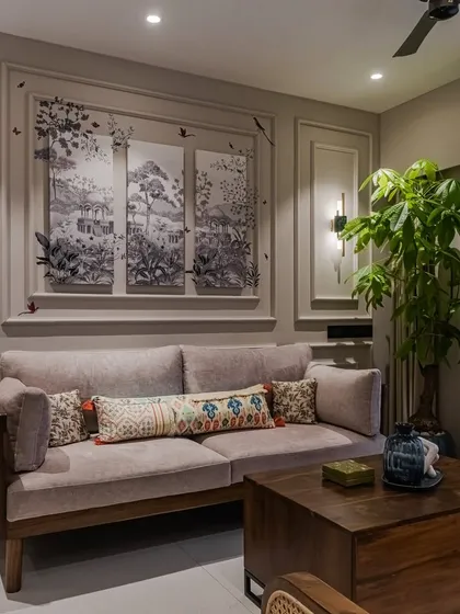 A close-up of the living area, highlighting the beautiful wall moulding that frames a triptych of art. This detail showcases our ability to integrate architectural elements with our bespoke furniture for a fully realized interior.
