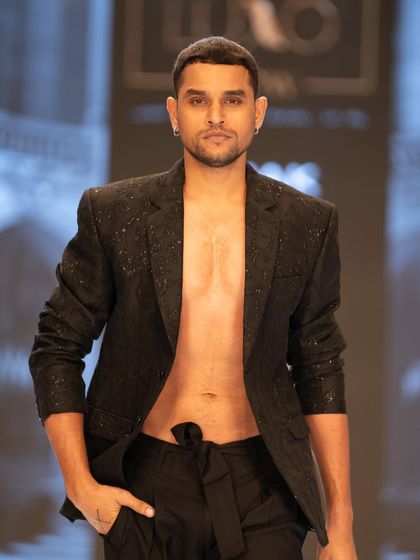 Grooming for a model at The Luxo Show. The look is fresh and clean, with a modern hairstyle to match the designer jacket.