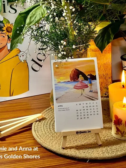 The April page of the calendar, 'Marnie and Anna at Goa's Golden Shores', displayed beautifully with some candles and my own self-portrait art in the background.