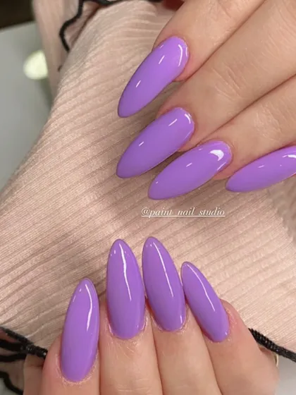 Lavender dreams. This solid, glossy lavender color on long, stiletto nails is the perfect shade for spring and summer.