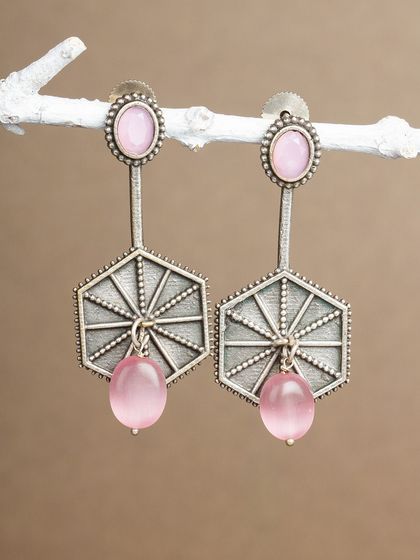 These long, geometric oxidized silver earrings with pink beads are a unique and stylish choice.