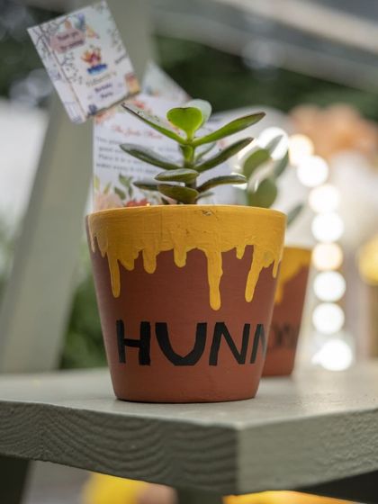 As party favors, we gave out these adorable 'hunny' pots with small plants. It's a sweet and sustainable way for guests to remember the day.