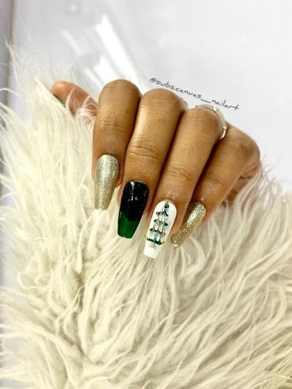 Another festive Christmas design combining gold glitter, dark green, and a white accent nail with a hand-painted Christmas tree. A perfect look for holiday parties.