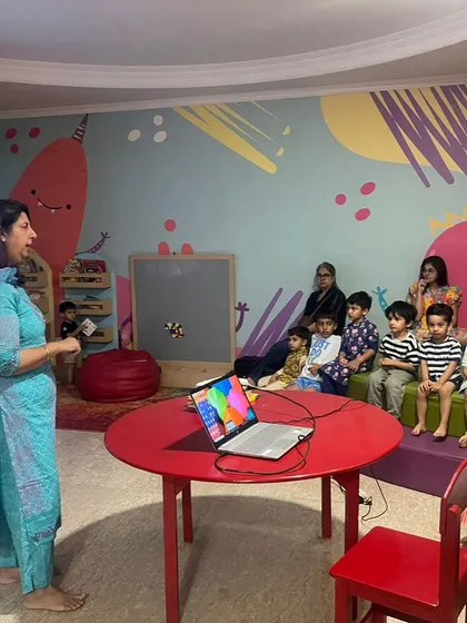 We use a mix of traditional storytelling and modern technology, like showing videos on a laptop, to celebrate festivals like Janmashtami.