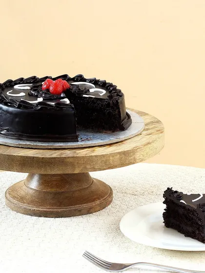 A look inside our classic rich chocolate cake. We bake every cake fresh to ensure it's moist and decadent, perfect for any celebration or just to satisfy a chocolate craving. This shows the soft texture you can expect with every order.