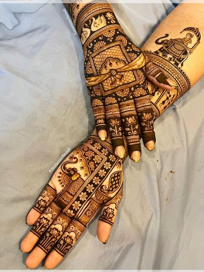 A beautiful bridal design featuring a mix of traditional motifs. The hands are adorned with elephants, swans, and a 'gathbandhan' (wedding knot) symbol.
