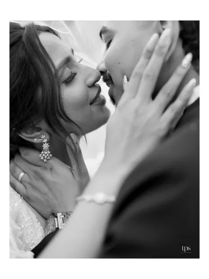 A beautiful black and white close-up capturing an intimate moment. The focus is on the gentle touch and serene expressions, creating a timeless and emotional portrait.