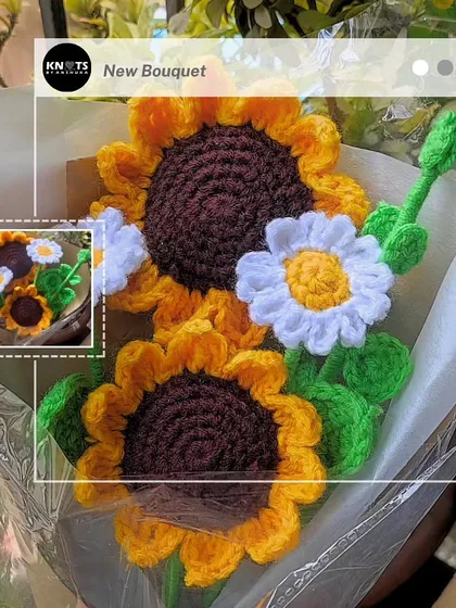 A lovely arrangement of two sunflowers and a daisy, wrapped and ready to bring a smile to someone's face.