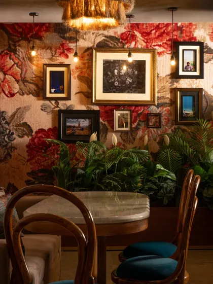 The interplay of textures is central to Echoes. A rugged floral wallpaper provides a dramatic backdrop for a gallery wall of vintage frames, weaving a sense of history and personality into the space.