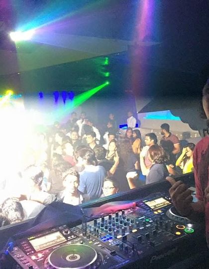 A big smile and a thumbs up for the camera during an early gig. The joy of playing for a live audience has never changed.