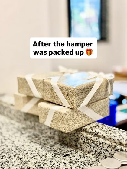 The final look of a custom-wrapped gift hamper, ready to be sent out. We use high-quality, patterned paper and ribbons to create a gift that feels special from the moment it's received.