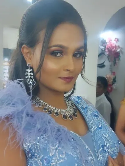 This client is wearing a modern American Diamond set with blue stones, perfect for a cocktail party or a glamorous evening event.