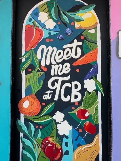 A straight-on view of the kitchen door mural, showcasing the playful lettering and vibrant illustrations of fresh ingredients.