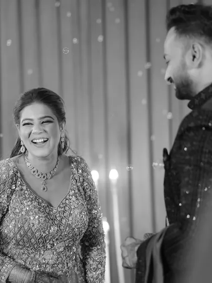 A beautiful black and white shot capturing the bride's infectious laughter during her Sangeet. These are the candid, happy moments we strive to create for our clients.