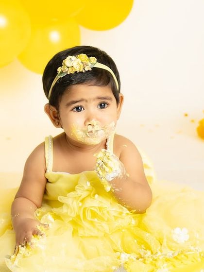 A moment of contemplation before the big smash. This photo captures the calm before the storm in a bright and cheerful sunflower birthday setting.