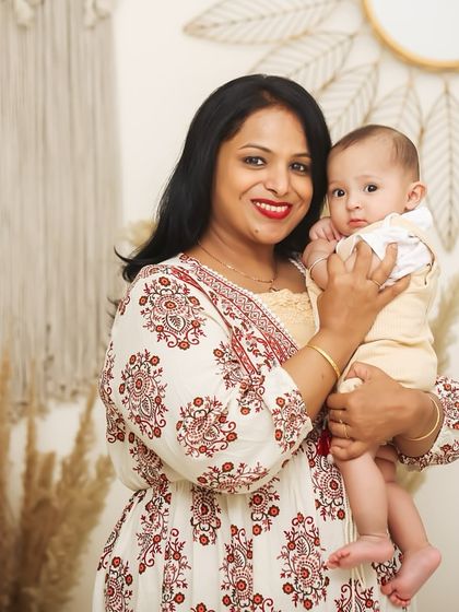 A beautiful portrait of a mother and her baby. The boho-chic studio setup with pampas grass and macrame adds a warm and stylish touch to this lovely family photo.