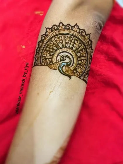 A beautiful bridal start-up design featuring a peacock within a semi-circular mandala, showcasing intricate feather details.