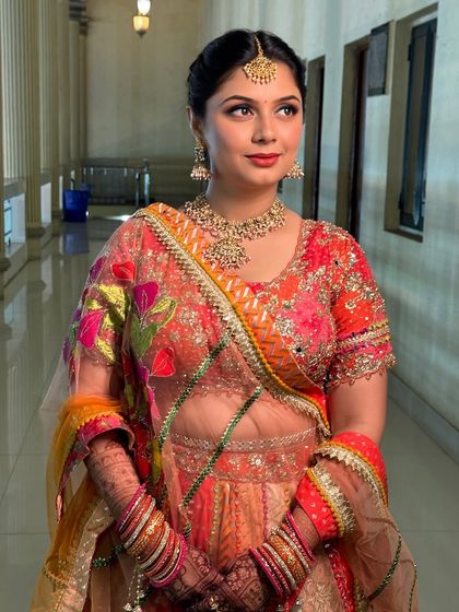 This shot highlights the beautiful blend of colours in her outfit and how the makeup enhances her festive look.