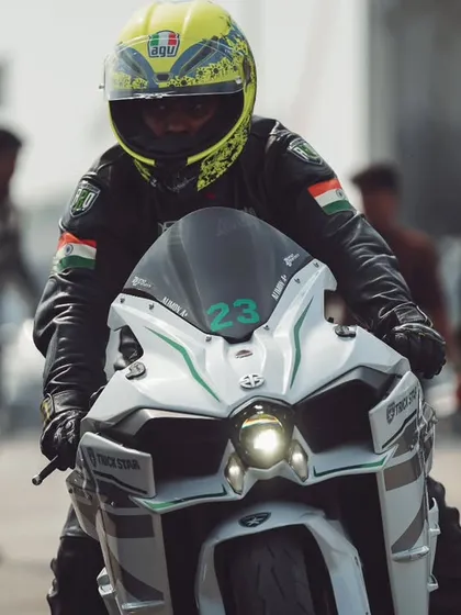 A rider on a Kawasaki Ninja H2, one of the most powerful production bikes in the world, smiles as they prepare for their run.