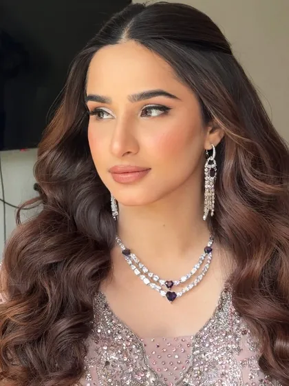 A stunning soft glam glow for Zainab's sangeet eve. This signature look features flawless skin, defined eyes, and voluminous waves.