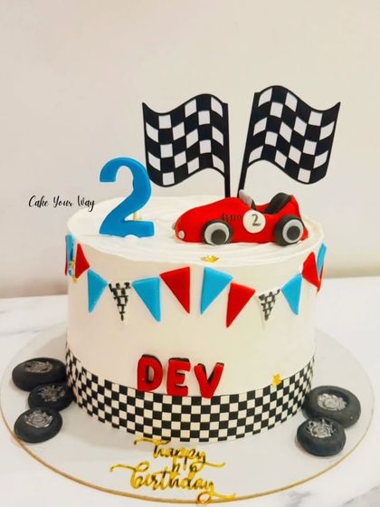 A classic race car theme for Dev's 2nd birthday, complete with checkered flags and fondant tires.