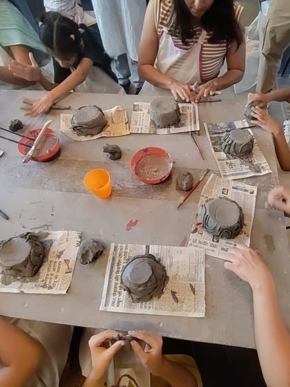 A top-down view of the table during our Mother's Day workshop, showing all the unique bowls being created. Each piece is as special as the person making it.