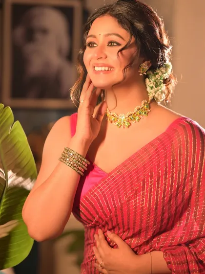 A candid, joyful moment from the Noboborsho shoot. The model's natural smile and the soft lighting create a feeling of warmth and happiness.