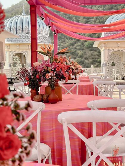 The guest seating area, with pink and orange drapes creating a colorful canopy against the sky. The white chairs and tables provided a crisp contrast, making the colors pop even more.