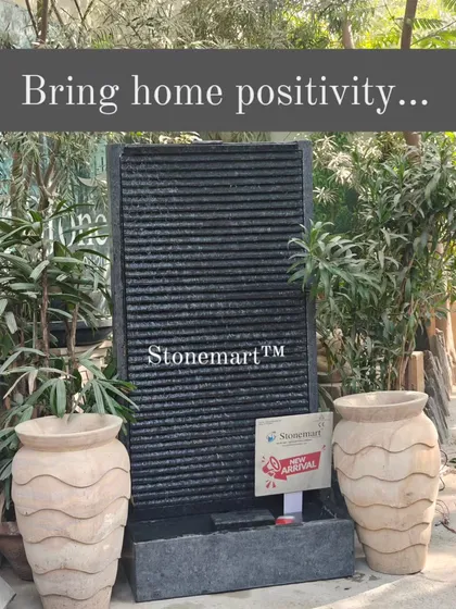 This 5-foot ribbed granite waterfall, shown here with two sandstone vases, is a perfect example of our work for modern interiors. It brings positivity and the calming sound of water to any space.