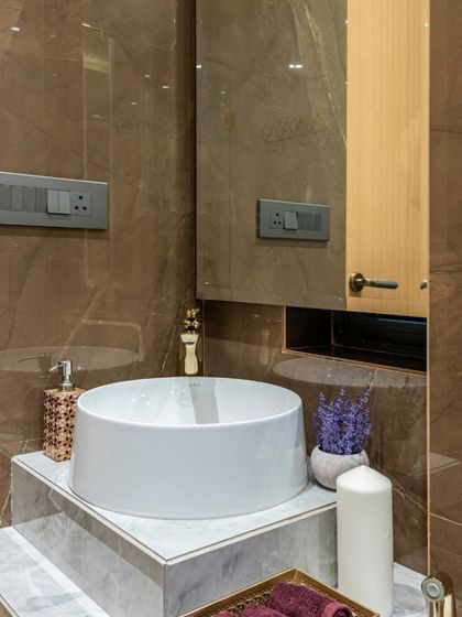 A detail of the powder room in the Filigree House, showing the stepped marble vanity. The design is simple yet elegant, showcasing the beauty of the natural stone.