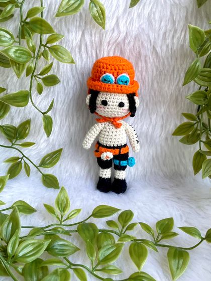 Ace from One Piece! I love creating anime characters because they are so unique and let me be creative. This doll features his signature hat, tattoos, and accessories.