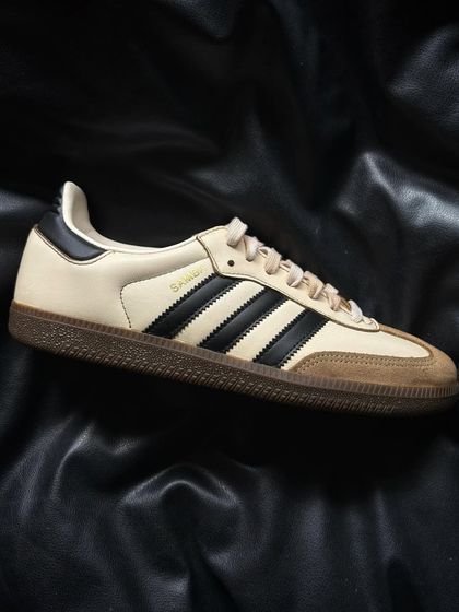 A pair of Adidas Sambas given a custom coffee-stain treatment for a vintage, worn-in look.