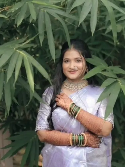 A stunning portrait of the engagement bride, her mehndi-adorned hands held gracefully. The design complements her beautiful lavender saree perfectly.